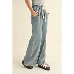 Be Cool And Unique In These Wide Leg Denim Pants Product Description: Introducing our Wisteria Denim Pants. These light wash, wide leg pants feature a drawstring and two front pockets. Perfect for a casual and comfortable look. (Denim never goes out of style, go ahead, rock these pants!) Fit: Model is 5'7" and is wearing a size Small. Material: 100% Cotton Denim Blue Jeans With Drawstring For Spring, High Rise Bottoms With Drawstring And Relaxed Fit, High Rise Relaxed Fit Bottoms With Drawstring, Casual Wide Leg Cargo Pants, Spring Denim Bottoms With Drawstring, Casual Wide Leg Cotton Pants With Drawstring, Wide Leg Cotton Jeans With Drawstring, Casual Denim Blue Jeans With Drawstring, Spring Casual High Rise Wide Leg Pants