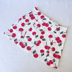 Cherry Print Mini Skirt Cherry print mini skirt made from deadstock cotton fabric.  Designed with panels to fit your curves perfectly. Matching corset available. None stretch thick cotton fabric. Invisible zip at the back. Length 16 inches as standard(can be altered at no extra cost) Lined for comfort Lovingly designed and artisan made in our Brighton Studio. Sizing: We offer a made to measure service or you can use our standard sizes as shown below. UK 8   - Waist 26 inches/ Hip 34 inches UK 10 Cotton Fitted Mini Skirt, Y2k Mini Cotton Skort, Y2k Style Stretch Cotton Skort, Fitted Cotton Mini Skirt For Summer, Stretch Cotton Mini Skort, Fitted Cotton Mini Skirt, Fitted Short Cotton Skirt, Red Slim Fit Printed Skirt, Y2k Style Cotton Stretch Skirt