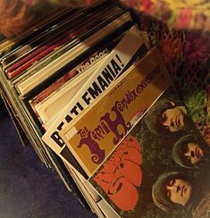 a stack of records sitting on top of a table