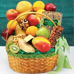 a basket filled with lots of different types of fruits and nuts on top of a table