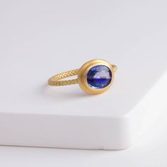 Description One-of-kind 18k yellow gold ring with a unique bi-color oval sapphire with darker and light blue hues, set in an east-west setting. The color of this sapphire is like seeing where the sky and the ocean meets at the horizon. This ring is in a rope design, adding a little more detail to every part of the ring. Details 18k Yellow Gold Size of sapphire – 7.1 x 6.1 x 2.8 mm (1.17 ct) Made in Japan *Please note that due to the natural quality of the stones, there may be inclusions, cracks, Fine Jewelry Sapphire Cabochon Ring, Fine Jewelry Sapphire Ring With Cabochon Cut, Blue Cabochon Sapphire Ring In Fine Jewelry Style, Fine Jewelry Blue Cabochon Sapphire Ring, Oval Yellow Sapphire Ring In Yellow Gold, Blue Cabochon Sapphire Ring In 14k Gold, Sapphire Bezel-set Oval Cabochon Ring, Oval Cabochon Sapphire Ring With Bezel Setting, Gold Oval Yellow Sapphire Ring