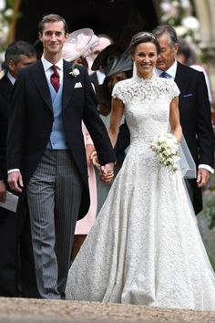 the newly married couple are walking hand in hand