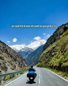 a man riding a motorcycle down a curvy road