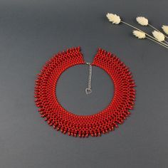 A red necklace is a stylish and original accessories for women. A dainty necklace will make you more tender and sophisticated. A statement necklace will be a wonderful gift for wife. Despite the size, the beaded necklace is not heavy.  A modern necklace is suitable for any look and is easily combined with clothes of different styles. All beaded jewelry in our assortment is unique. Each product has its own style and original design. Nevertheless, many pieces of jewelry are easily combined with ea Elegant Bib Necklace With Dangling Beads As Gift, Elegant Bib Necklace With Dangling Beads For Gift, Elegant Red Bib Necklace For Party, Red Bridal Choker Necklace For Party, Red Beaded Chain Necklace For Wedding, Red Choker Bridal Necklace For Party, Red Bridal Necklace With Round Beads For Party, Red Round Bead Necklaces For Party, Elegant Bib Necklace With Colorful Beads As Gift