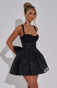 Time to glow in Polly, the sparkliest mini to wear for those special occasions. We love the cinched waist and contrasting full skirt, with detachable bow to the back to finish the look. Style yours with glowing makeup and heeled mules. 



Colour: Black Sparkle.

Sparkle stretch mesh fabric.

Fully lined.

Underwired cups.

Ruched details.

Tulle attached to lining for added volume.

Full skirt with gathering at waist.

Detachable bow detail to back.

Invisible zipper fastening.

Mini length.

 Size: XS, S, M, L, XL, XXL Mini Hoco Dresses, Black Dress Sparkle, White Dress Spring, Midi Dress Wedding Guest, Black Sparkly Dress, Sparkly Mini Dress, Prom Dress Inspo, Prom Dress Ideas, Maxi Dress Sale