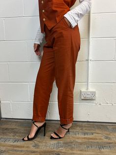 Product: 3 Piece - Jacket, waistcoat and trousers (Pants). Colour: Burnt Orange Product Status: Pre Order Promo Starting with the jacket, it has 2 workable pockets in the front and also a working chest pocket at the front. The closure is a two button closure and the back is double vented. The jacket also has an inside pen pocket and the inside lining is plain black. Moving on to the waistcoat, it consists of two working front pockets, and the closure is a 4 button closure. The back has an adjust Utility Blazer With Flap Pockets For Work, Tailored Work Pants With Pockets, High-waisted Pants With Flap Pockets For Work, High-waisted Workwear Bottoms With Flap Pockets, Tailored Pantsuit With Pockets, Tailored Workwear Pants With Side Pockets, Tailored Chinos For Fall Workwear, Tailored Chinos For Workwear, Fall Season, Workwear Pantsuit With Pockets And Suit Collar