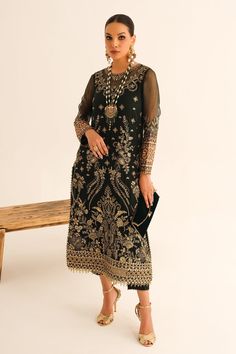 Pakistani Embroidered Long Kameez With Capri and Dupatta look bright clad in this lushly endowed design. Golden and Black threadwork is decked with shiny gold cupped spangles used abundantly adding bling to this obsidian base. The overall look of the ensemble is enhanced by the addition of intricate embroidered patterns of dupatta sequin and tilla embroidered motifs on them. The chiffon dupatta is decorated with embroidered ogee pattern added with a four-sided border to complete the look. It com Lucknowi Kurta, Pure Cotton Suits, Ogee Pattern, Bridal Dupatta, Kurta Dress, Pakistani Designer Suits, Eid Dresses, Pure Chiffon, Party Wear Lehenga