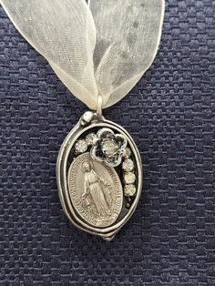 "This uniquely designed micro-mosaic pendant features a Catholic devotional medal. A lovely pendant, created in an imported  ornate sterling silver bezel that is nickel and lead free, and features a vintage Miraculous Medal, silver finish charm and faux diamond accents. Rustic, yet elegant, this pendant is a lovely way to show your devotion to the Blessed Virgin. 1\" x 1.25\". Pendant only." Miraculous Medal Necklace, Georgetown Tx, Catholic Jewelry, Micro Mosaic, Blessed Virgin, Miraculous Medal, Our Lady, Jewelry Necklace Pendant, Embellishments