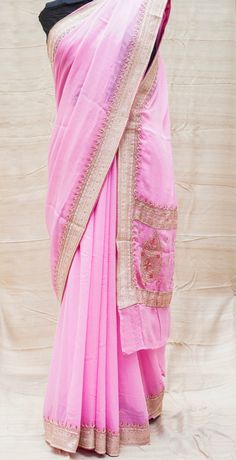 Category: Georgette Saree An exclusive Banarasi saree from Khinkhwab. Add a dash of your favorite color to your ethnic look with this beautiful Banarasi saree. Fabric - Pure Georgette Silk Georgette is a lightweight, crinkled and sheer fabric, displaying an overall bouncy look. A strong absorbent, Georgette is easy to dye and has a dull-rough texture. Georgette is made from twisting yarns of silk. Color -Pink Weave - Kadwa Craftsmanship - Ari zardozi work material used: Dabka(Saadi),sequins, res Embroidered Tussar Silk Pre-draped Saree For Diwali, Pink Georgette Pre-draped Saree With Embroidered Border, Chanderi Cutdana Pre-draped Saree, Eid Chanderi Pre-draped Saree With Traditional Drape, Chanderi Pre-draped Saree For Navratri, Semi-stitched Pre-draped Saree With Resham Embroidery For Puja, Eid Chanderi Pre-draped Saree, Designer Embroidered Border Sharara For Navratri, Traditional Chanderi Pre-draped Saree With Resham Embroidery