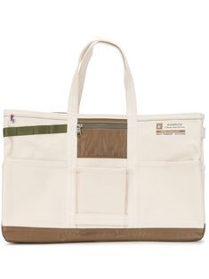 a large white bag with brown trims on the front and side pockets, sitting against a white background