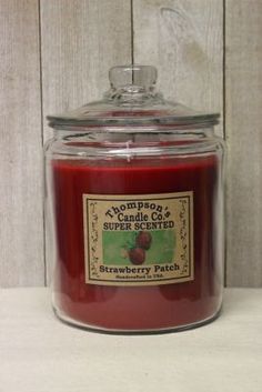 a glass jar filled with a red candle