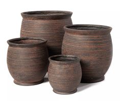 three brown vases sitting next to each other on a white surface