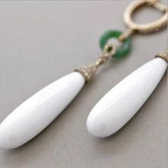 A stylish and chic pair of drop earrings! They feature 27.35 carats of smooth drop-shaped white onyx. Accenting them are 0.41 carats of round brilliant-cut diamonds which add sparkle and brilliance to the piece. Finishing the earrings are two jadeite jade hoops which add length and contrast in color to this unique piece. Made in 18k rose gold and ready to be enjoyed.      Length: 2.5 inches    Weight: 9.2 grams Luxury Teardrop Diamond Earrings, Luxury Teardrop Earrings With Diamond Accents, Classic White Teardrop Earrings With Diamond Accents, Elegant White Long Drop Earrings, Luxury White Teardrop Earrings, Timeless White Drop Jewelry, White Diamond Long Drop Earrings, White Diamond Earrings For Formal Occasions, Formal White Diamond Gemstone Earrings