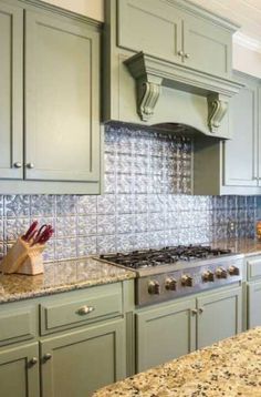 a kitchen with green cabinets and granite counter tops