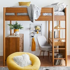 a loft bed with a desk and chair in the corner, next to a yellow chair