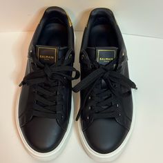 Balmain Women’s Black And Gold Sneakers. Black On The Side Of Shoes And Gold On The Back. Women’s Size 6. In Great Condition Luxury Black Sneakers With Rubber Sole, Luxury Black Low-top Sneakers, Classic Black Custom Sneakers With Studded Outsoles, Designer Black Low-top Sneakers, Black Leather Sneakers With Studded Outsoles, Luxury Black Lace-up Sneakers, Luxury Black Low-top Custom Sneakers, Designer Black Leather Sneakers, Luxury Black Lace-up Custom Sneakers