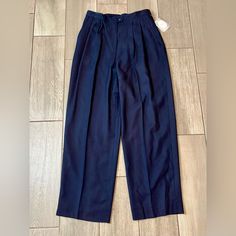 Elevate Your Professional Wardrobe With These Navy Blue Pleated Pants By Christian Dior. Crafted From 100% Worsted Wool, They Provide A Luxurious Feel And Drape Beautifully. The Pants Are Brand New With Tags And Are Perfect For Any Career Wear Occasion. The Pants Are Designed With Women In Mind And Come In Size 14. The Blue Color Adds A Touch Of Sophistication To Your Look And Pairs Well With A Variety Of Tops. The Material Is Soft, Warm, And Comfortable, Making It Perfect For Any Season. Invest Navy Wide Leg Formal Pants, Navy Wide Leg Pants For Formal Occasions, Classic High-waisted Wide Leg Pants In Blue, Blue Classic Wide Leg Formal Pants, Blue Classic Formal Wide Leg Pants, Navy High-waisted Formal Pants, Classic Blue Wide Leg Pants For Formal Occasions, Spring Formal Navy Pants, Navy Formal Bottoms For Spring