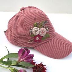 a pink baseball cap with flowers on it