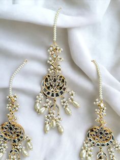 Mirror work and gold plated, this set is perfect for bridesmaid or mehendi/Sangeet to wear with any outfit! Elegant Wedding Bridal Earrings With Zari Work, Elegant Chandbali Jewelry Sets With Zari Work, Elegant Kundan Danglers With Mirror Work, Gold Bridal Earrings With Mirror Work For Parties, Kundan Bridal Earrings With Zari Work, Kundan Bridal Earrings With Zari Work For Wedding, Elegant Festive Tikka With Matching Earrings, Elegant Mirror Work Jhumkas For Wedding, Elegant Mirror Work Jhumkas For Diwali