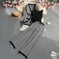 This two-piece knitted top and wide leg pants set offers a comfortable and stylish option for any occasion. The soft, stretchy material of the top and pants provides a flattering fit, while the wide leg design adds a touch of sophistication. - Color: Brown, Black, Grey- Style: Two-Piece Top + Pants- Pattern Type: Geometric- Sleeve Length: Long Sleeve and Sleeveless- Neckline: V-neck- Pants Length: Full Length- Fabric: Polyester - Details: Lace Up- Occasion: Casual- Gender: Women- Size: One Size Elegant Stretch Two-piece Set, Black Wide Leg Summer Sets, Chic Stretch Sets For Loungewear, Trendy Stretch Wide Leg Sets, Chic Wide Leg Sets For Fall, Elegant Knit Pants For Loungewear, Casual Fall Sets With Wide-leg Pants, Chic Wide-leg Pants Sets, Elegant Stretch Pant Set For Spring