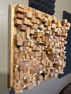 a wooden wall sculpture made out of wood blocks