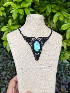 Embrace nature's beauty with this stunning handcrafted macrame necklace. At its heart lies a mesmerizing blue-green labradorite stone, known for its ethereal play of colors that shimmer like the northern lights. Key features: * Centerpiece: Oval blue labradorite cabochon * Necklace style: Adjustable  * Material: Durable black wax cord * Technique: Intricate macrame knotwork * Style: Bohemian, earthy, organic This necklace beautifully marries skilled craftsmanship with raw natural elements. The l Turquoise Macrame Necklace As Gift, Turquoise Macrame Necklace For Gift, Handmade Artisan Necklaces With Waxed Cord, Macrame Necklace With Waxed Cord As A Gift, Handmade Artisan Necklace With Waxed Cord, Artisan Handmade Jewelry With Waxed Cord, Handmade Artisan Jewelry With Waxed Cord, Bohemian Macramé Necklace With Waxed Cord, Artisan Macrame Necklace With Waxed Cord