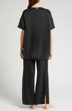 These mulberry-silk pajamas are naturally hypoallergenic, breathable and ideal for those with sensitive skin; best part—they can go in the washing machine. The elegant set pairs an oversized high-low T-shirt with flowy pants enhanced with split cuffs and side-seam pockets. Top has 28" front length, 30 1/2" back length; bottoms have 29" inseam, 25" leg opening, 12 1/2" front rise, 16 1/2" back rise (size Medium) Top has scoop neck; short sleeves; chest patch pocket; high/low hem Pants have back e Silk Sleepwear For Loungewear In Relaxed Fit, Silk Sleepwear Relaxed Fit For Loungewear, Silk Tops With Relaxed Fit For Loungewear, Silk Sleepwear For Loungewear In Casual Style, Casual Silk Sleepwear For Loungewear, Casual Silk Sleepwear, Hem Pants, Elegant Sets, Flowy Pants