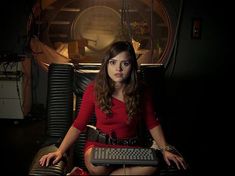 a woman sitting in a chair with a keyboard