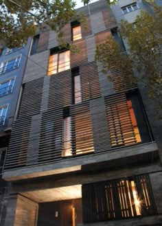 an apartment building that has wooden slats on the front and side of it's windows