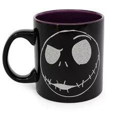 a black and purple coffee mug with the face of jack skellingy on it