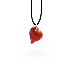 Handcrafted by Dan Neff, these heart pendants are the perfect way to show your love. They are available in amber, green, teal, purple, pink, and red. *Please note that while we do our best to create a cohesive series, not every piece will be identical as it is all handmade and subject to variations. Includes gift box and black satin cord that is adjustable from 14" to 26". Dimensions: 1.5" long x 1" wide Handmade Heart Cut Necklaces As Gift, Teardrop Heart Charm Jewelry Gift, Heart Beads Necklaces For Valentine's Day Keepsake, Adjustable Heart Pendant Necklace For Her, Adjustable Heart Pendant Necklace As A Gift For Her, Adjustable Heart-shaped Necklace For Her, Valentine's Day Heart Charm Teardrop Jewelry, Adjustable Heart Necklace As A Gift For Her, Valentine's Day Heart Beads Necklace Keepsake