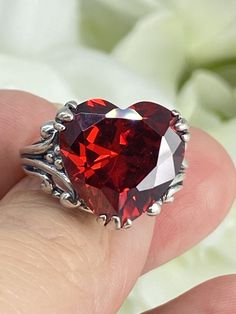 Red Garnet CZ Heart Gem Sterling Silver RingHeart Leaf Design#D213 This Gothic inspired lovely filigree ring is set with a 10ct flawless red cubic zirconia gemstone. This heart gemstone is 15mm x 15mm. The rings sits 11mm off the finger. Notice the beautiful gothic design of the silver filigree setting and band. The inside of the band is marked 925 for sterling silver. This is an exquisite rendition of an antique filigree ring. The sterling filigree cradles the stone in a delicate caress. Classi Heart Gem, Antique Filigree, Gothic Design, Heart Gemstone, Cubic Zirconia Rings, Deco Jewelry, Filigree Ring, Silver Filigree, Art Deco Jewelry