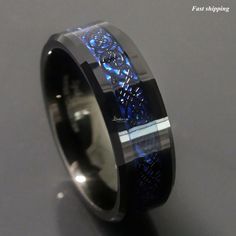 a black and blue ring with an intricate design inlaying the inside of it