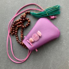 "Vegan Eco Leather Medicine Bag with a Czech Glass Lotus Bead accented with Healing Crystals. Shaman Bag or Amulet Pouch to wear around your neck-or hang in your Car or keep on your Altar. Makes a great Mala Bag...or you could keep your EarPods in it. Two Color Choices: *Orchid Bag features Rose Quartz Stones *Lime Green Bag features Genuine Turquoise Stones A place for things that have Spiritual Meaning for you-your Sage,Crystals,or that pretty rock your 3 year old gave you.... A unique,origina Gift Pouch Shoulder Bag For Mobile Phone, Small Mobile Phone Bag As Gift, Gift Mobile Phone Pouch Shoulder Bag, Mobile Phone Clutch Pouch, Beaded Pouch Shoulder Bag As Gift, Pink Phone Bag With Removable Pouch As Gift, Handmade Pouch Bag, Beaded Pouch Shoulder Bag For Gift, Handmade Shoulder Phone Bag For Gift