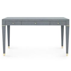 a grey desk with two drawers and gold handles on the top, against a white background