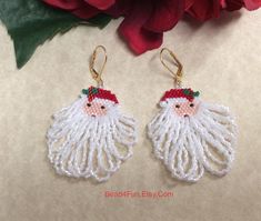 a pair of earrings that have been made to look like santa's beards