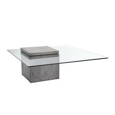 a glass and concrete coffee table with a square base on the top, in front of a white background