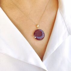 This stunning pendant is set in 14K Solid Yellow Gold with Natural Ruby with utmost precision. It is an unique gemstone pendant for nearly every occasion and is completely hassle-free jewelry. ITEM DETAILS * Gem: Ruby * Gem Size: 20X20 mm * Gem Shape: Round  * Gem Weight: 16.33 carats * Gold Purity: 14KT  * Gold Weight: 0.63 gram * Total Weight of the Pendant: 3.90 gram The Gold purity is guaranteed and it comes with authentic 14KT gold hallmark. Since my items are handmade, they are absolutely nickel and lead free. CUSTOMIZATION * Gemstone customization is available and it can be substituted with a gem of your choice. Kindly message me for the same. PACKAGING * The Pendant comes with layers of safe and secure wrapping along with Free handmade jewelry box with every purchase. ➡️Head to the Yellow Gold Gemstones With Bezel Setting, Ruby Round Pendant Birthstone Necklace, Ruby Gemstone Round Pendant Jewelry, Ruby Necklace With Polished Finish As Gift, Ruby Necklace With Polished Finish For Gift, Polished Ruby Necklace For Gift, Round Pendant Gemstones With Gemstone Accents As Gift, Ruby Round Pendant With Polished Finish, Ruby Round Pendant Jewelry With Polished Finish