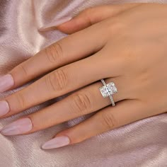 a woman's hand with a diamond ring on it