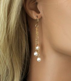 "Sophisticated and Elegant Pearl Earrings that feature beautiful white Swarovski Pearls that gracefully dangle from gold filled chains. The chains are all different lengths making these earrings perfect to add the right touch of elegance to any wedding dress or bridesmaids dress. Each is suspended from gold filled ball french ear wires. [MATERIALS] * High Quality Swarovski Pearls * Dainty 14kt Gold Filled Chain * 14kt Gold Filled Ear Wires These beautiful earrings measure (47mm) 1-7/8\" in lengt Elegant Chandelier Earrings With Adjustable Chain For Party, Elegant Long Drop Dangling Beads Jewelry, Elegant Long Drop Jewelry With Dangling Beads, Pearl Chain Dangle Chandelier Earrings, Elegant Dangling Beads Drop Earrings, Elegant Drop Earrings With Dangling Beads, Chandelier Earrings With Adjustable Chain As Gift, Elegant Long Drop Chandelier Earrings With Dangling Charms, Wedding Linear Dangle Earrings With Beads