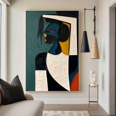 an abstract painting hangs on the wall next to a couch in a modern living room