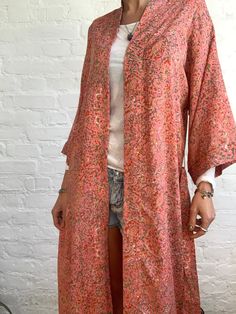 "This is beautiful silky upcycled robe in coral colour with delicate floral print Made free size with wrap tie closing and wide kimono sleeves Easy and fun to wear around the house or can be used on holidays as a beach cover up It is very comfy and feels soft and light the material is colourful indian saree silk made into this unique stylish over all MEAESURE free size length 55\" MATERIAL *saree silk, no lining more available at https://www.etsy.com/shop/AltheaStores? CARE INSTRUCTIONS * Wash i Bohemian Relaxed Fit Kimono For Daywear, Flowy Tunic Kimono For Loungewear, Vintage Open Front Kimono For Summer, Relaxed Fit Robe For Home Use In Spring, Spring Loungewear Kaftan With Kimono Sleeves, Spring Kaftan With Kimono Sleeves For Loungewear, Long Summer Robe For Sleep, Spring Tunic Kimono For Loungewear, Bohemian Long Sleeve Kimono For Daywear