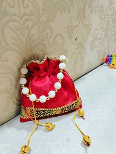 A unique handmade potli bag..using raw silk fabric and embellishments..You can carry it to any occasion..ve it small outing or a wedding Fancy Potli Bags, Bollywood Style Bag With Latkans For Gift, Festival Pouch Potli Bag With Latkans, Festival Potli Bag With Latkans As Gift, Handmade Potli Bag For Navratri Festival, Handmade Potli Bag For Navratri Festivities, Bollywood Style Potli Pouch Bag For Festivals, Bollywood Style Festive Potli Pouch Bag, Handmade Festive Potli Bag For Navratri