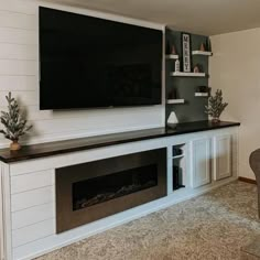 a flat screen tv mounted to the side of a wall above a fireplace in a living room