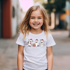 Kids will love this Ghost Christmas youth short sleeve tee. This lightweight side-seamed shirt maximizes comfort all day long.  Christmas shirt Kids Toddler Youth, Santa T Shirt, Holly Jolly Shirts for Kids, Boy Toddler Christmas Outfit 🌟100% Airlume combed and ringspun cotton (fiber content may vary for different colors) 🌟Light fabric (4.2 oz/yd² (142 g/m 🌟Retail fit RETURNS: All products are made-to-order and because of the nature of these items, all sales are final unless they arrive damag White Short Sleeve Top For Holiday, White Holiday Top With Short Sleeves, White Short Sleeve Holiday Top, White Short Sleeve Christmas Top, White Short Sleeve Top For Christmas, White Family Matching Christmas T-shirt, Pre-shrunk White Christmas Shirt, White Pre-shrunk Christmas Tops, White Family Matching T-shirt For Holidays