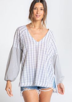 Perfectly relaxed and effortless, this cotton top is designed in a classic mixed plaid print. Featuring voluminous long sleeves, a subtle high/low hemline, and delicate shirring details. The raw unfinished hem adds a lived-in feel. FINAL SALE Mixed plaid print Relaxed, oversize fit Voluminous long sleeve Elastic wrist cuff High/low hemline Raw-edge hem Side vents V-neckline Shirred detail at the back Slightly sheer Cotton shirt Model is 5'9, wearing a size S.Style: I-13864W-RTM-MP White Relaxed Fit Yarn-dyed Top, Effortless Cotton Blouse For Fall, Effortless Long Sleeve Cotton Blouse, Fall Casual Shirt With Balloon Sleeves, Casual Fall Shirt With Balloon Sleeves, Casual Balloon Sleeve Shirt For Fall, Effortless Long Sleeve Cotton Top, Plaid Cotton Blouse For Fall, Oversized Plaid Blouse For Spring