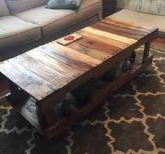 a wooden coffee table sitting on top of a rug