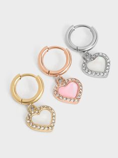 Brighten up your day and style with these feminine Annalise heart-stone hoop earrings. Semi-precious pink heart-shaped stones -- wreathed in crystals for eye-catching sparkle -- hang off shiny rose gold-tone hoops. Sweet in their simplicity, this pair is fabulous for everyday wear as they will complement a wide range of outfits, from the casual to the dressy. Pair it with the Annalise heart-stone ring to create a pretty coordinated look. Due to the nature of semi-precious stones, the actual product received may vary from the product images shown on the website. Colours may appear lighter or darker, including veining variations that may also vary slightly from piece to piece. Belt Ring, Heart Stone, Charles Keith, Stone Heart, White Heart, Rose Gold Earrings, Crystal Heart, Shiny Silver, Semi Precious Stones