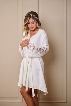 Our beautiful Circon Dressing Gown made in a soft and imposing Via Spiga with an elegant drape, accompanied by guipure on the sleeves, making it the ideal dressing gown for you. V-neck Lace Trim Nightgown For Wedding, V-neck Wedding Nightgown With Delicate Lace, V-neck Delicate Lace Nightgown For Wedding, V-neck Lace Wedding Nightgown, Lace V-neck Nightgown For Weddings, White Lace Trim Wedding Sleepwear, Lace V-neck Sleepwear For Wedding, V-neck Robe With Lace Trim For Wedding Night, Long Sleeve Lace Wedding Sleepwear