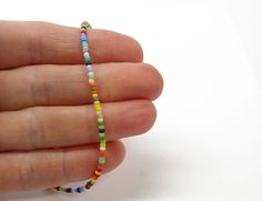 "A tiny rainbow bead anklet. This is such a cute multi color seed bead anklet! The colors include, purple, orange, red, white, green, sky blue, yellow and pink, just to name a few! The beads are made from glass. I hand string these seed beads on beading wire and finish them with a sterling silver lobster clasp and small length of sterling silver chain. This anklet has a 1\" sterling silver chain extension. The length on the listing is the total length measured end to end including the extension. Casual Multicolor Anklets With Tiny Beads, Casual Multicolor Tiny Beads Anklets, Casual Multicolor Round Beads Anklets, Multicolor Round Beads Anklets As Gift, Multicolor Round Beads Anklets For Gift, Gift Multicolor Round Beads Anklets, Gift Multicolor Round Bead Anklets, Rainbow Beads, Beaded Anklets